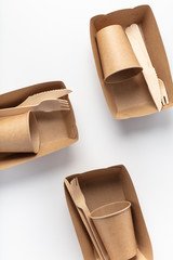 Organic dishes, the view from the top on the packaging. Wooden fork and knife, a glass. Recycling and eco-friendly disposable tableware.