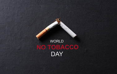 World No Tobacco Day concept, May 31. Soft focus of quitting smoking or No smoking sign made with broken cigarettes on black background.