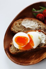 soft boiled egg on cream cheese toast for gourmet comfort breakfast