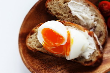 soft boiled egg on cream cheese toast for gourmet comfort breakfast