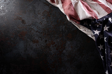 Happy Memorial Day. American flags  against a black stone texture background. May 25.
