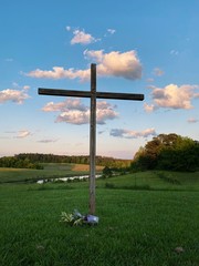 Cross with rolling hills and a blue sky
