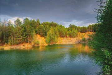 Mountain lake surrounded by forest. Spring landscape.