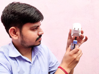 Evaporation all out  machine refill in hand of young man or boy to eliminate mosquito for...