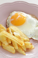 homemade French fries and sunny side up fried egg with broccoli 