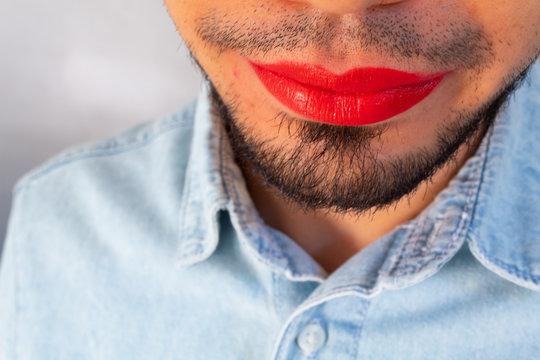 close up of the lips of a bearded man with red lipstick