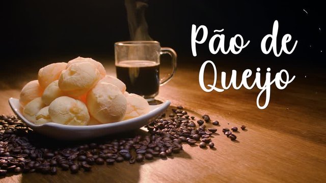 A typical Brazilian food, P&atilde;o de queijo. Next to it appears written in Portuguese P&atilde;o de queijo