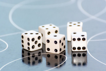 Dice on a table with reflections