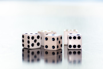 Dice on a table with reflections
