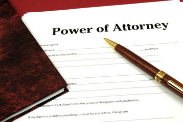 Power of Attorney Form ready to sign with book and pen. - obrazy, fototapety, plakaty