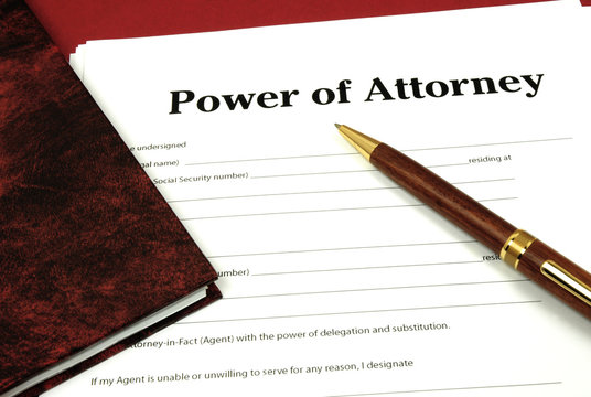 Power Of Attorney Form Ready To Sign With Book And Pen.