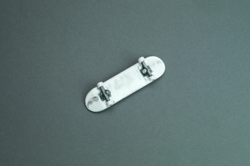 Small skateboard on color background. tiny skate for fingers. fingerboard close up