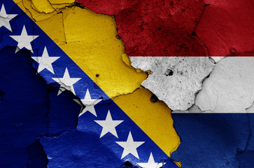 flags of Bosnia and Herzegovina and Netherlands painted on cracked wall