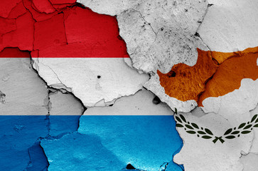 flags of Luxembourg and Cyprus painted on cracked wall