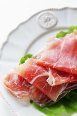 sliced ham on plate with copy space for gourmet