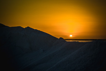 Naklejka na ściany i meble Sunset with orange sky and mountain of salt
