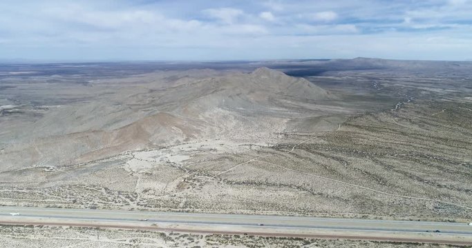 Highway road in the middle of empty deserted mountainous environment
