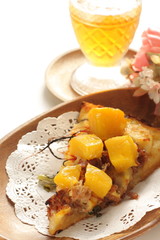 Piece of tropical fruit mango and beef Pizza on wooden plate