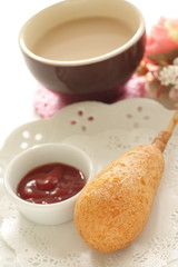 Corn dog and ketchup on dish for fast food