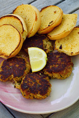 Platter of cooked crabcakes with fresh lemon