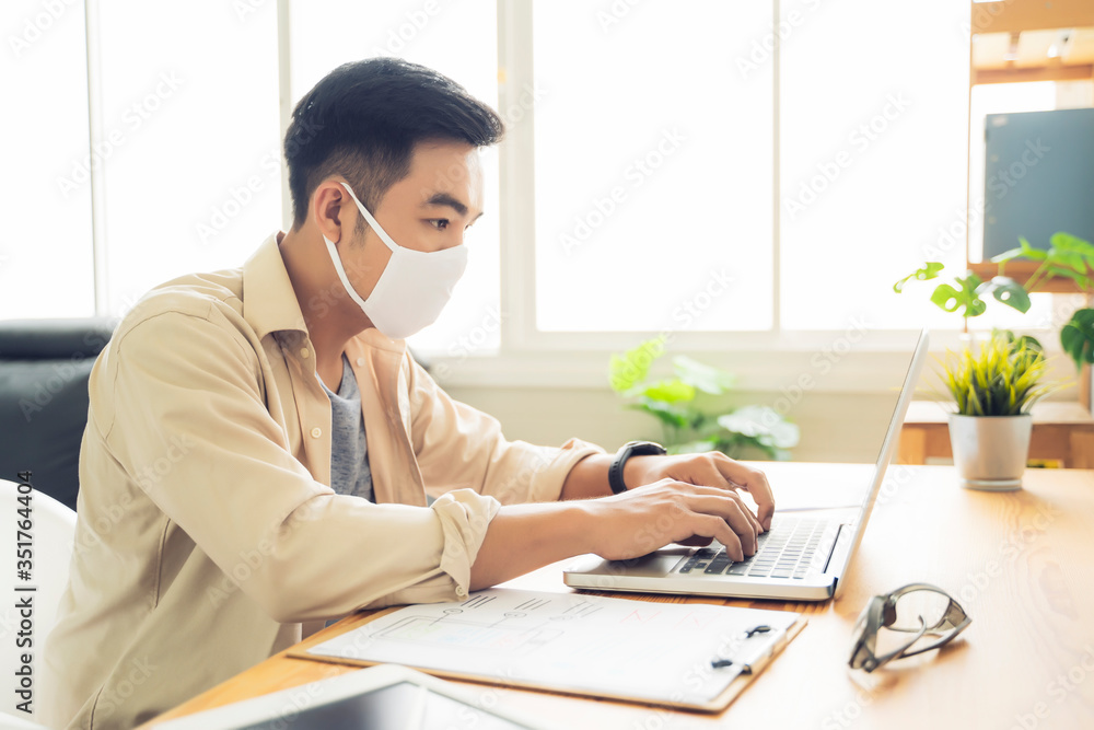 Fototapete Working from home web designing graphical user interface UX UI, using computer laptop and tablet device designing creative planning innovative idea, protective facemask quarantine coronavirus covid-19