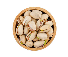 Pistachio in wood bolw on a white back ground
