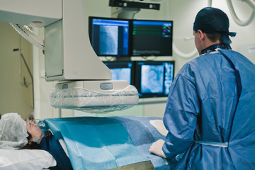 Cathlab in modern hospital with doctor, nurse and patient