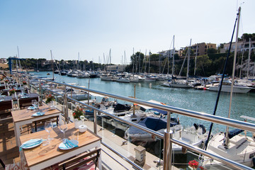 Fototapeta na wymiar Landscape of bar and boats in Porto Cristo, Majorca