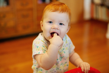 Girl on her first birthday with birthday presents