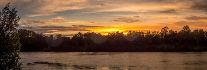 Panoramic Riverside Sunrise with Reflections