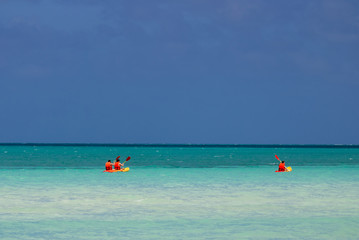 Fototapeta na wymiar Kayaking on the turquoise Caribbean ocean with a blue sky