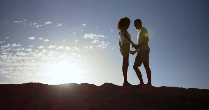 Couple standing on rock at beach