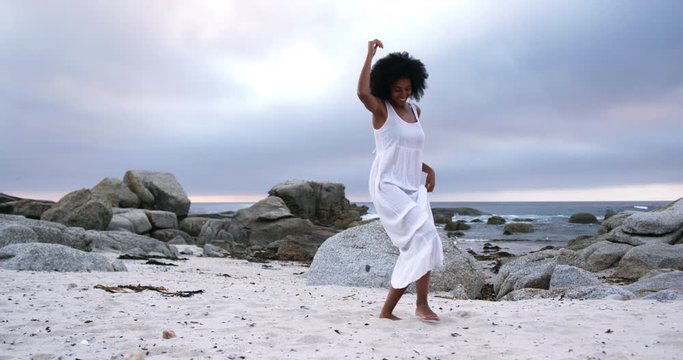 African American woman dancing on the beach