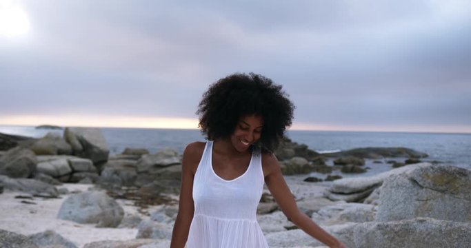 African American woman dancing on the beach