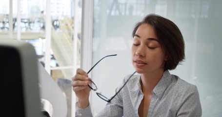 Businesswoman working on computer at desk in office
