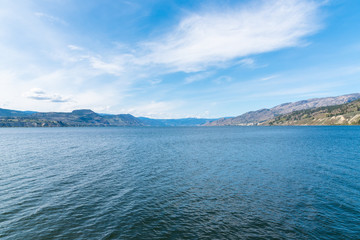 View from Naramata Wharf Park of Okanagan Lake, blue sky, and distant  mountains in Okanagan Valley