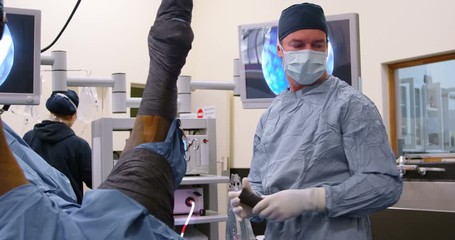 Surgeon operating a horse in operation theater - Powered by Adobe