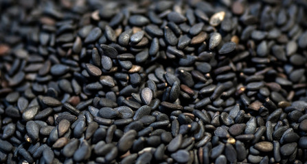 black sesame seeds on wood background
