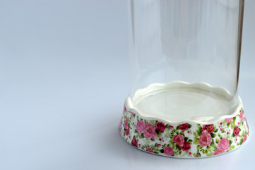 An empty glass food container isolated from a white background