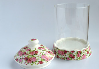 An empty glass food container isolated from a white background