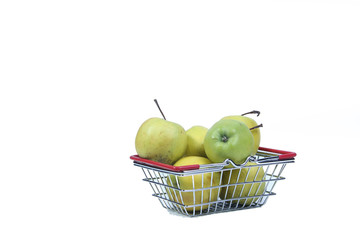 green apples in a shopping basket isolated on white background
