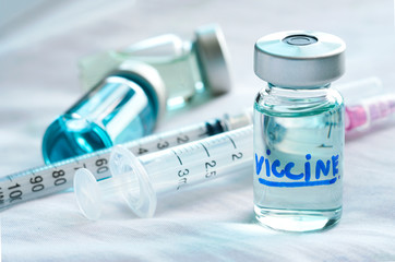 a syringe and a blue vaccine  Remdesivir bottle at the hospital. Health and medical concepts
