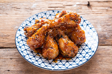 Sour-sweet baked chicken wings sesame and  teriyaki sauce.