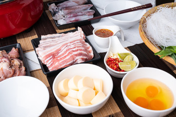 Sukiyaki . Preparation of raw materials,beef,egg ,tofu,vegetable and mung bean noodle  for sukiyaki using hot pots.