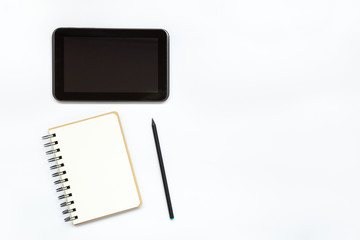 Notepad, pencil and tablet. Accessories for work. Office desktop. Minimalism. With copy space