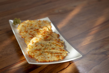 mashed cheeses in a white plate with a bunch of oregano
