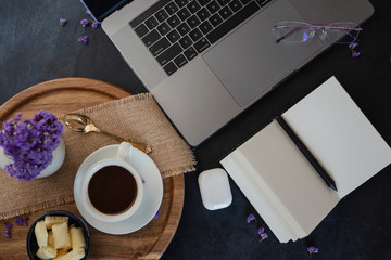 Top view of workplace with laptop and coffee