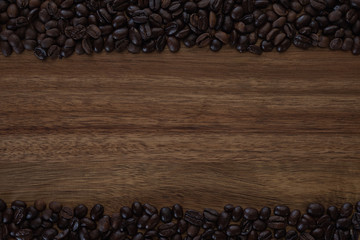Coffee beans and wooden background. Top view. Copy space.
