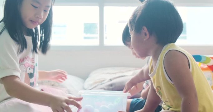 Adorable boy and girl kid group playing toy in cozy room developement preschool education