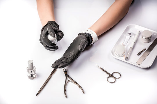 Tools for manicure hand in black glove. Master preparing her instruments for disinfection